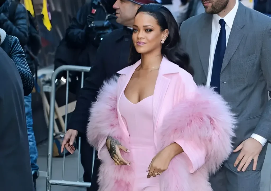 Chic pink winter outfit with fluffy coat sleeves at a city event, stylish fashion inspiration.