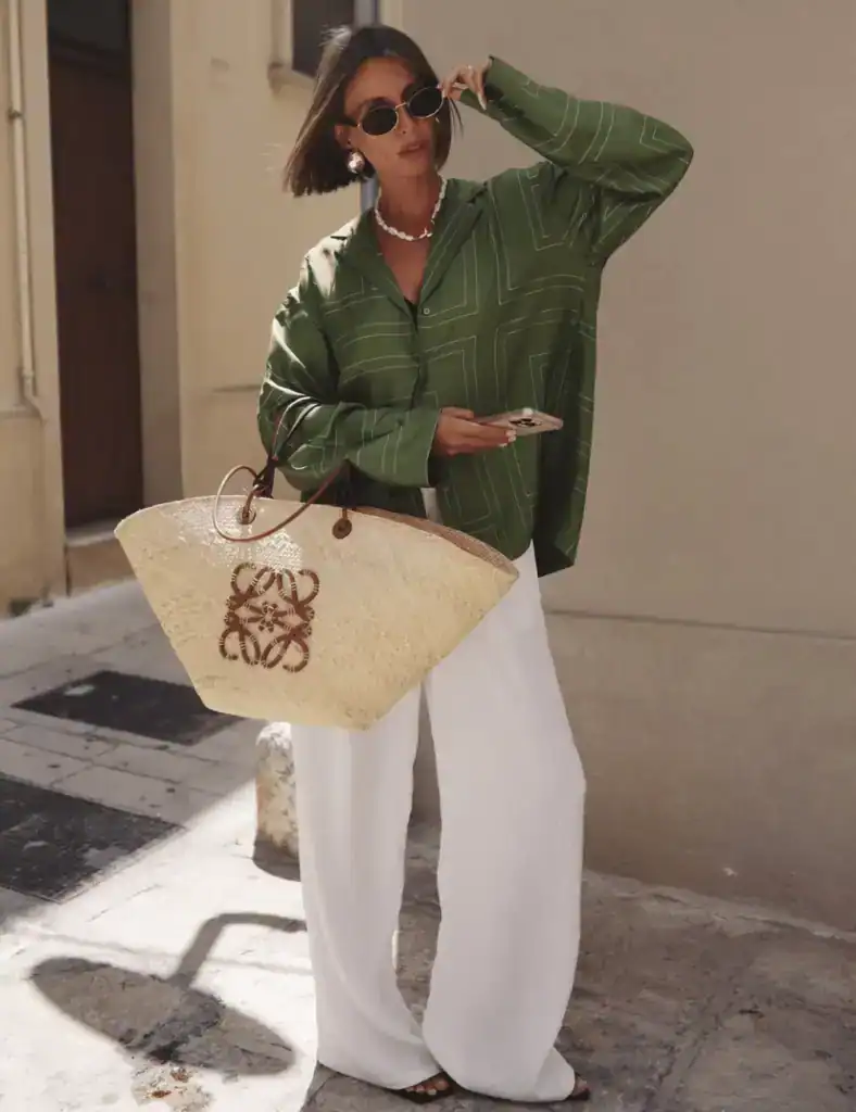 young woman with short brown hair wearing a loose-fitter green shirt with linen trousers. old money outfit ideas for women