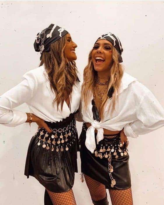 Trendy women in stylish outfits with camo headscarves, metallic skirts, and bold fashion accessories.