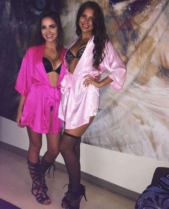 Two college girls in colorful robes and lingerie pose for Halloween best friend costume ideas.