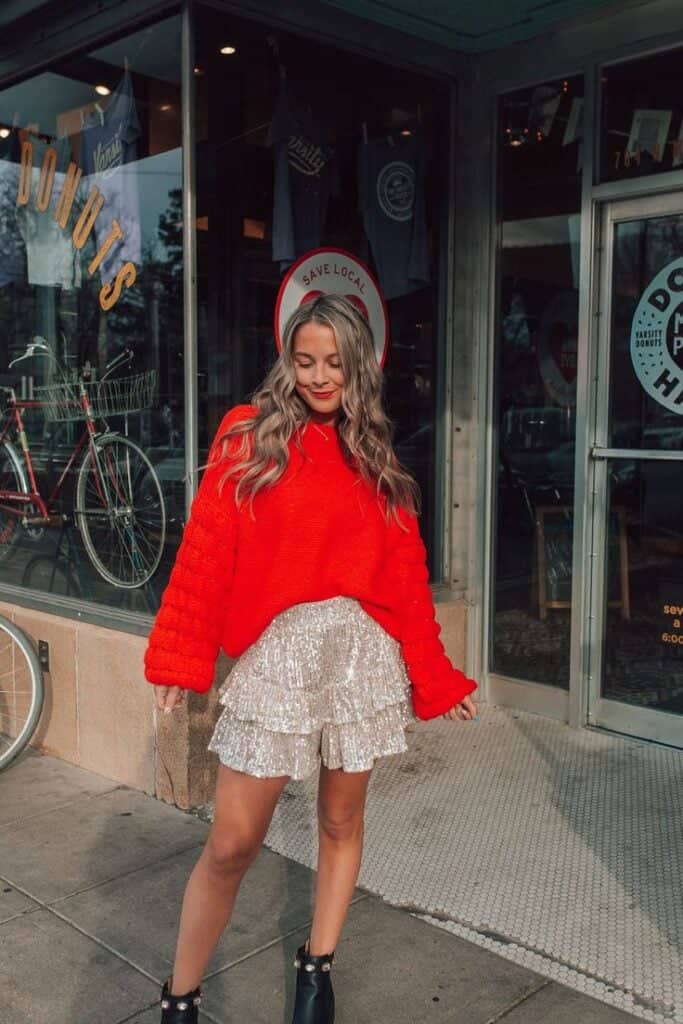 best outfits for v day date night loose red sweater and festive skirt