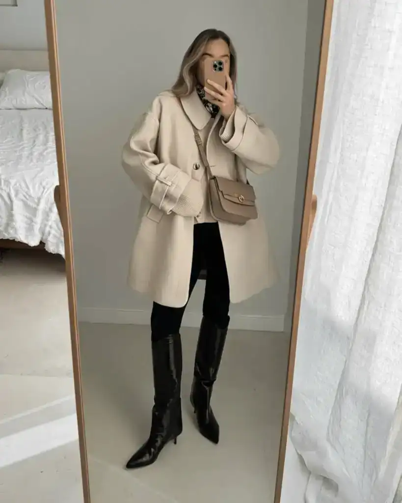 cream coat with long black boots outfit