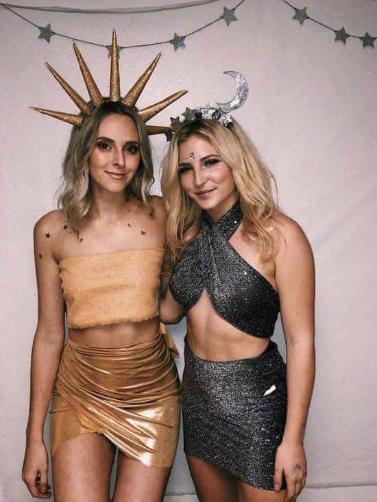 Best friend celestial sun and moon Halloween costumes, gold and silver outfits, star decorations.