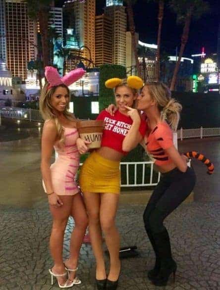 Three women in cute Halloween costumes posing together in Las Vegas nightlife.