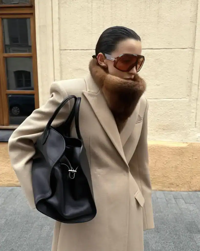 fur snood outfit with light beige coat and black bag