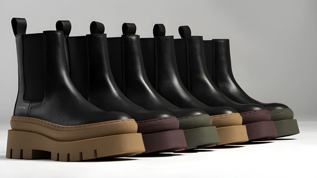 Trendy black Chelsea boots with chunky color platform soles in stylish modern footwear lineup.