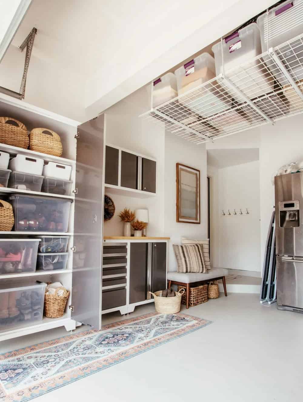 an organized garage featuring built in storage and upper storage