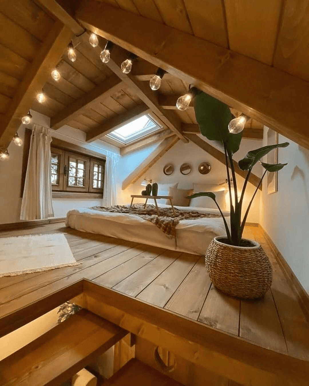 Cozy Loft Bedroom with Warm Lighting and Staircase