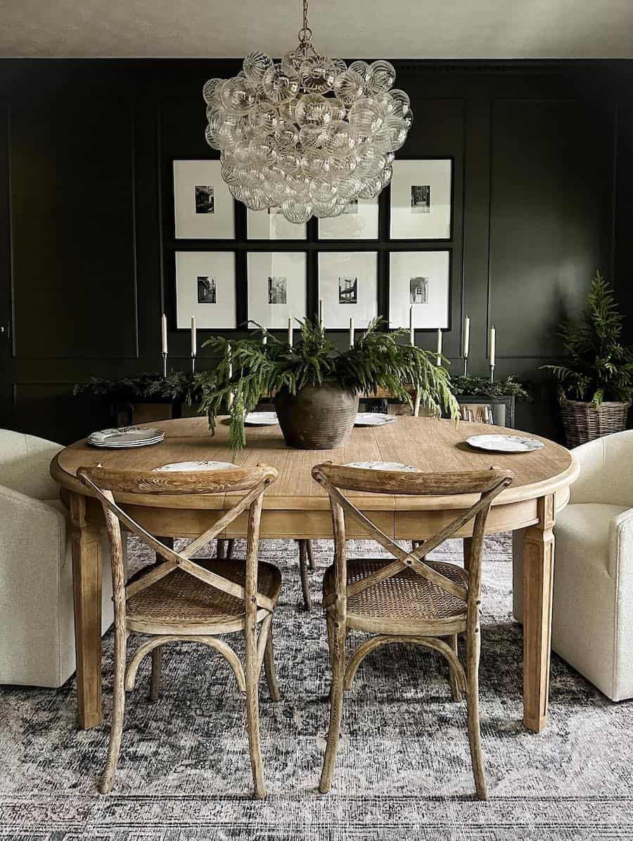 a dining table with pine decor and ivory candles