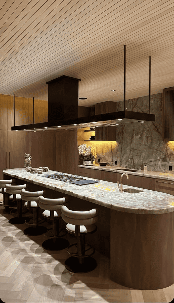 Marble Countertop Island With Black Pendant Lights And Seating