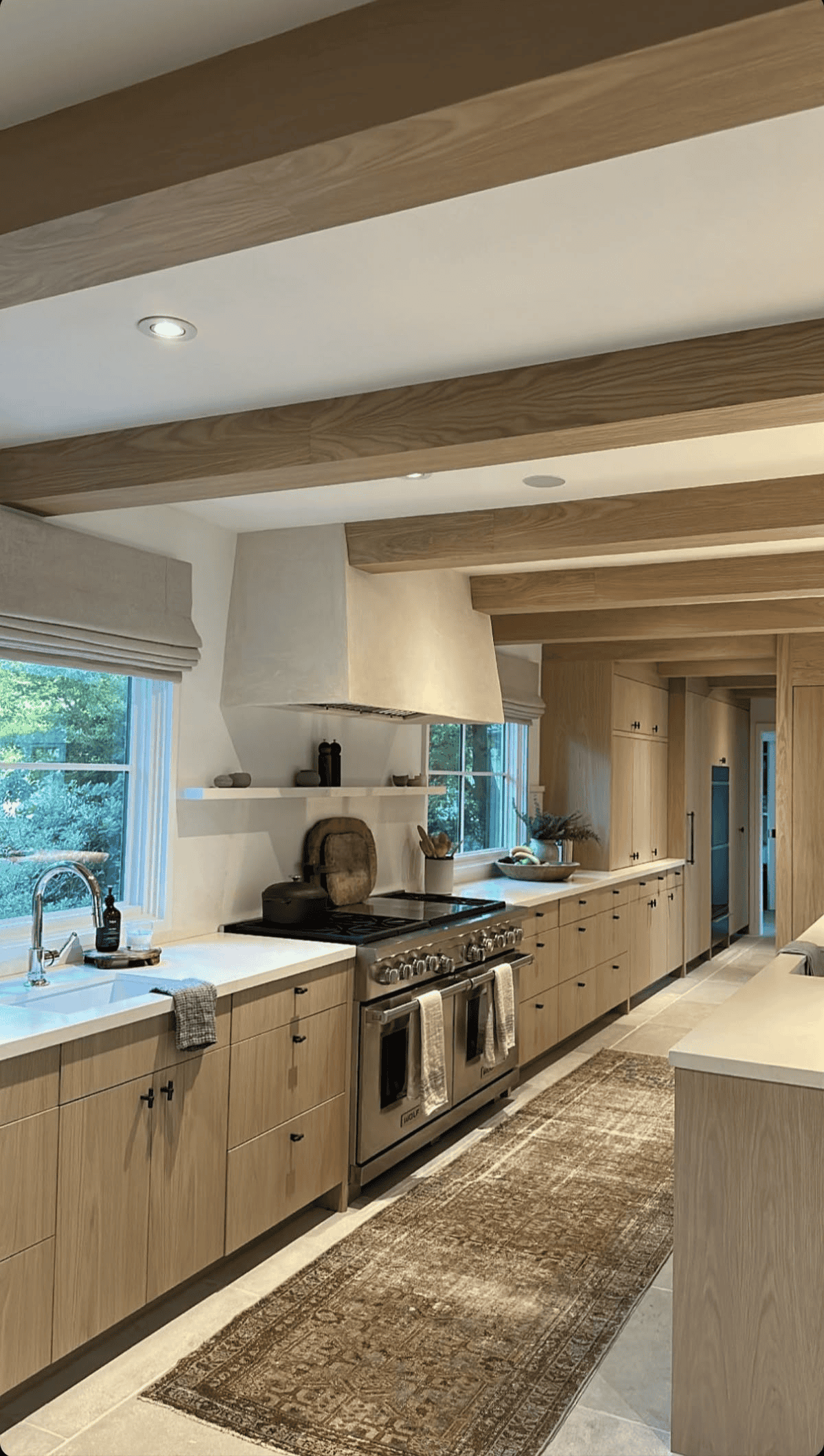 Natural Wood Cabinets And Island With A Comfortable Rug