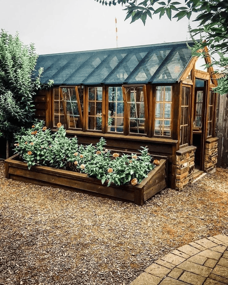 Wooden Greenhouse Includes a Built-In Planter Box